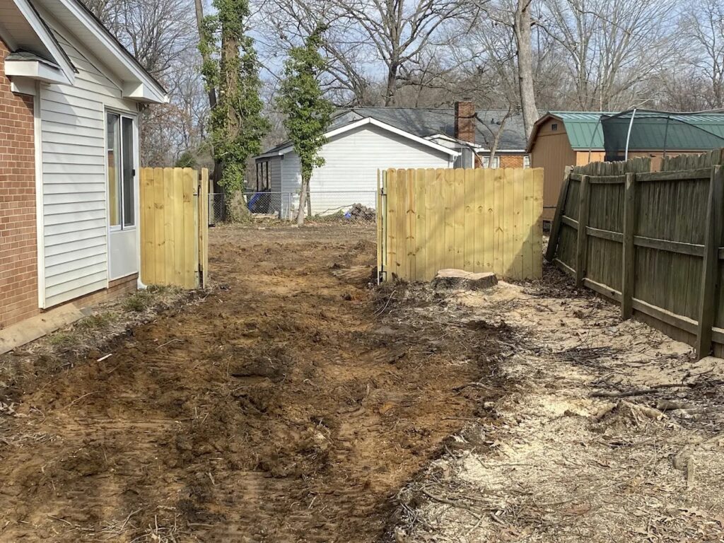 Backyard cleared and leveled after professional tree removal service in Greensboro, NC